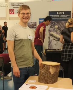 Aleksa stands by a tree trunk at Scifest